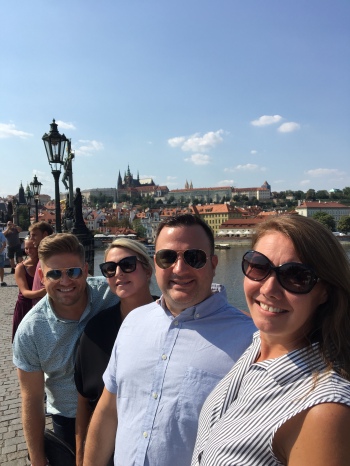 Crossing the Charles Bridge...smiling in spite of the heat